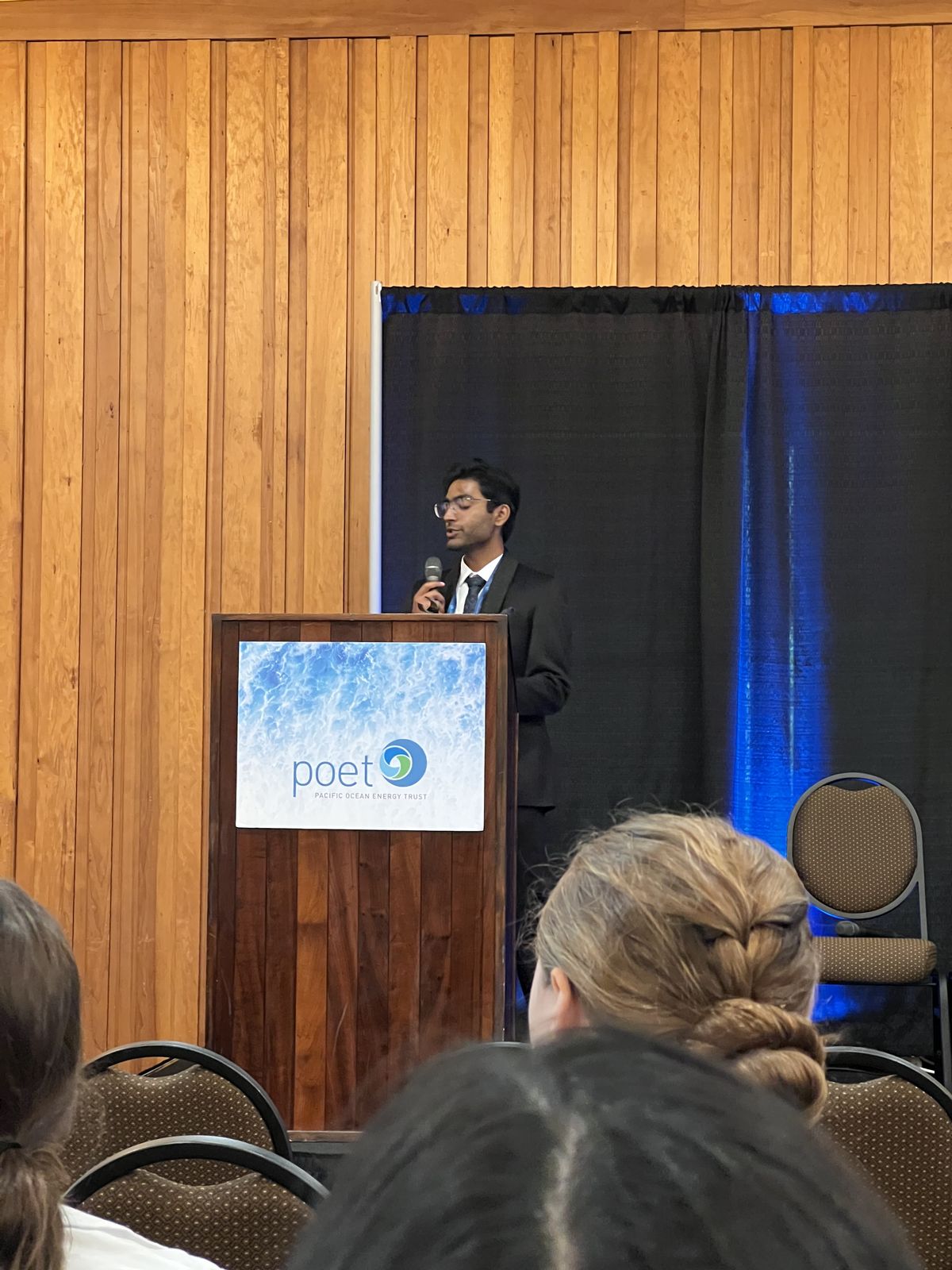 Samarth pitching ThermOcean at a podium during the DOE MECC conference in Portland, 2026.